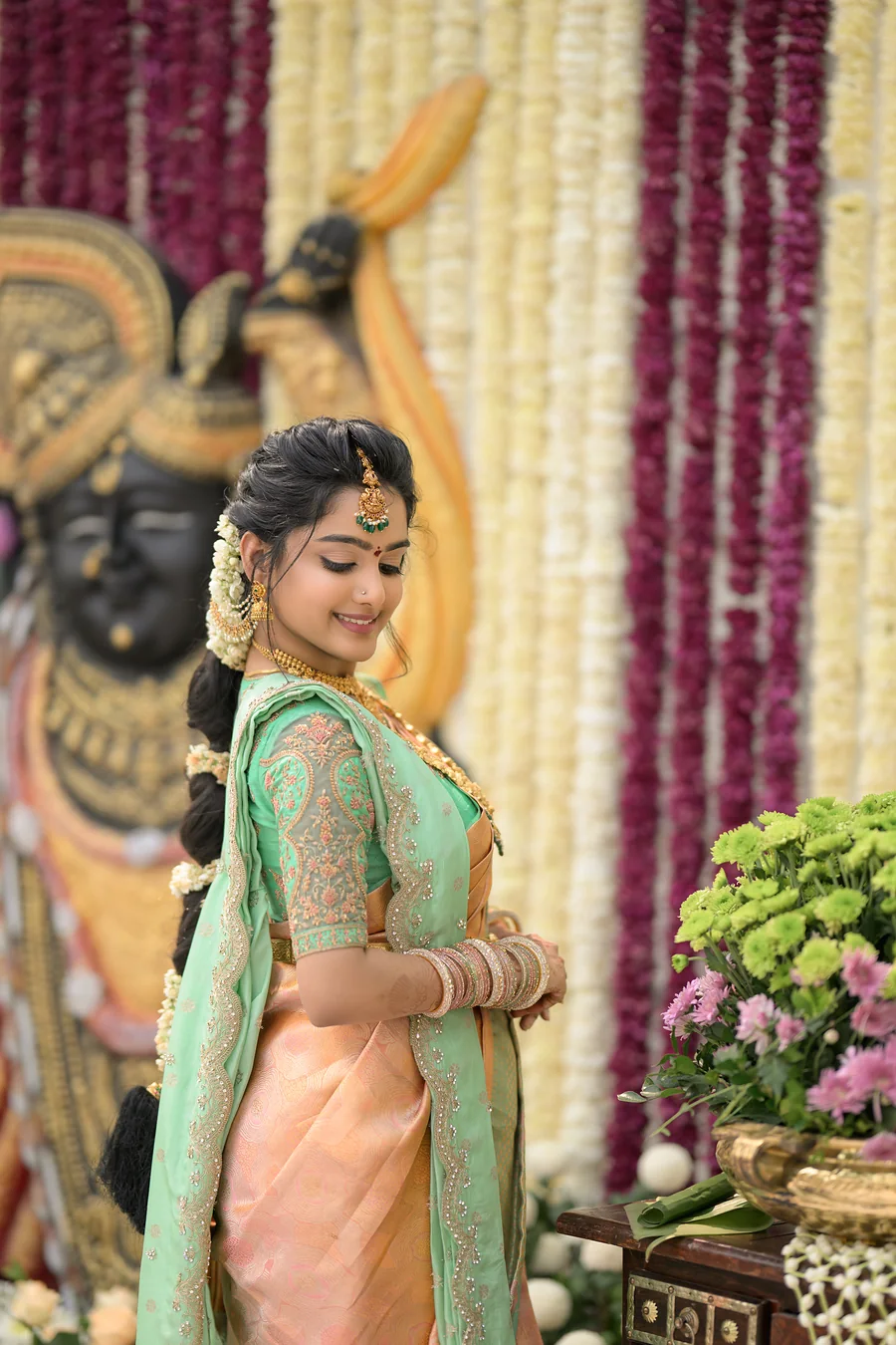 Harini Veena in a peach and mint silk saree with jasmine in her braid