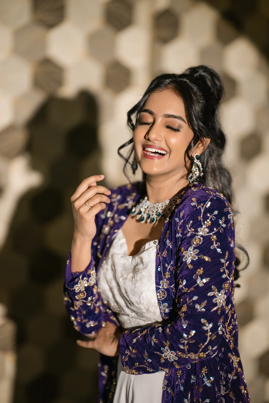 Harini Veena laughing in an embroidered purple velvet jacket